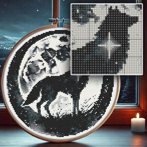 May include: Black and white cross-stitch embroidery of a wolf howling at the moon. The embroidery is framed in a round wooden hoop.