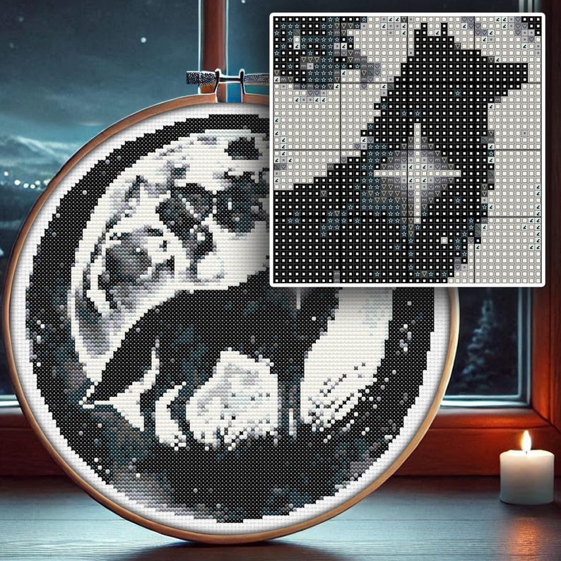 May include: Black and white cross-stitch embroidery of a wolf howling at the moon. The embroidery is framed in a round wooden hoop.