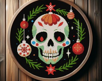 May include: A cross-stitch embroidery in a wooden hoop features a sugar skull design with Christmas ornaments and greenery on a black background. The skull is white and green with red accents, surrounded by red and white ornaments.