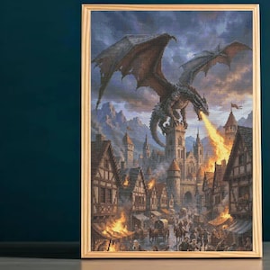 May include: A framed wall art piece depicting a large, dark-scaled dragon with expansive wings perched atop a stone castle tower. The dragon breathes a stream of bright orange fire over a medieval village with timber-framed houses and people.