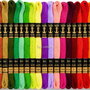 May include: A selection of Anchor embroidery floss in a rainbow of colours, from blues and greens to pinks and oranges. Each skein is labelled with the brand name and colour codes. The floss is arranged to display a wide range of shades.