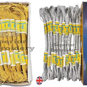 May include: Two boxes of metallic thread, one gold and one silver. Each box contains 25 spools of thread. The boxes are labelled "Gautam Metallic Threads" and "Fast Colour".