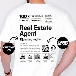 May include: White t-shirt with the text "Real Estate Agent" and a QR code. The shirt has a graphic design with the words "100% Element" and "Sold Property". The shirt also has the text "@johndoe_realty".
