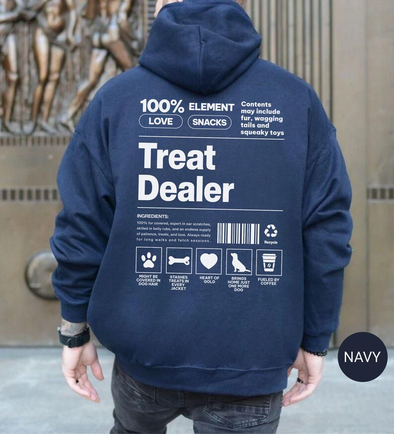 May include: Navy blue hoodie with the text "Treat Dealer" in white. The back of the hoodie features a list of ingredients and icons related to dogs, such as a paw print, bone, heart, dog silhouette, and coffee cup.
