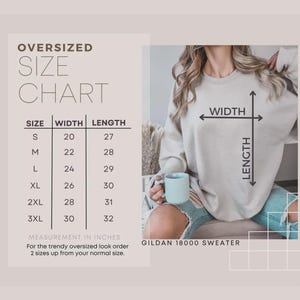 May include: An image featuring a size chart for an oversized Gildan 18000 sweater. The chart lists sizes S to 3XL, with corresponding width and length measurements in inches. A person is wearing the sweater, holding a mug. The text advises ordering two sizes up for an oversized fit.