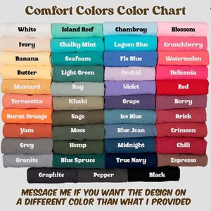 May include: A Comfort Colors color chart displaying folded fabric swatches in various shades. Text includes Comfort Colors Color Chart, Wearable Facts, and a message about requesting different colors. The grid shows white, pastels, brights, and darks.