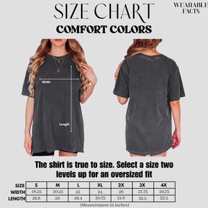 May include: Size chart for Comfort Colors t-shirts. The chart includes measurements in inches for width and length, ranging from size S to 4X. The text advises selecting a size two levels up for an oversized fit. The image shows a person wearing the shirt.