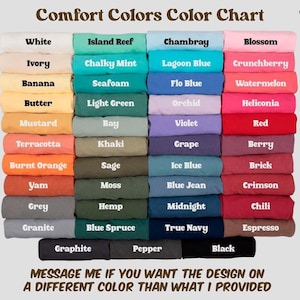 May include: A color chart titled "Comfort Colors Color Chart" displays a variety of fabric colors. The chart includes shades like white, ivory, banana, butter, mustard, terracotta, burnt orange, yam, grey, and granite. The text "MESSAGE ME IF YOU WANT THE DESIGN ON A DIFFERENT COLOR THAN WHAT I PROVIDED" is also visible.