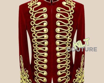 May include: A red velvet jacket with gold braid trim and buttons. The jacket has a mandarin collar and a zip closure. The text "KILT COUTURE" is visible on the right side of the jacket.