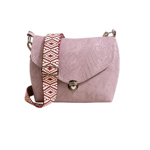 May include: A lavender crossbody bag with a floral embossed design. The bag has a patterned strap in burgundy and white. The bag features a metal clasp and hardware.