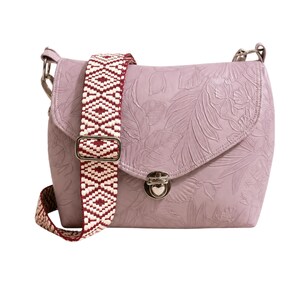 May include: A lilac-coloured crossbody bag with a floral embossed design. The bag features a patterned strap in white and burgundy. The bag has a silver-coloured clasp and hardware.