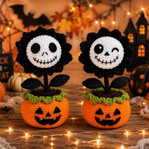 May include: Two crocheted flowers with white skull faces and black petals, each planted in an orange crocheted pumpkin pot with a jack-o'-lantern face. One skull has round black eyes, while the other has a winking eye and a round eye.