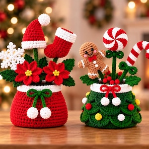May include: Two crocheted Christmas-themed pots. The red pot holds a white snowflake, a red Santa hat, a red stocking, and red poinsettia flowers. The green pot features a gingerbread man, a red and white peppermint, and a candy cane.