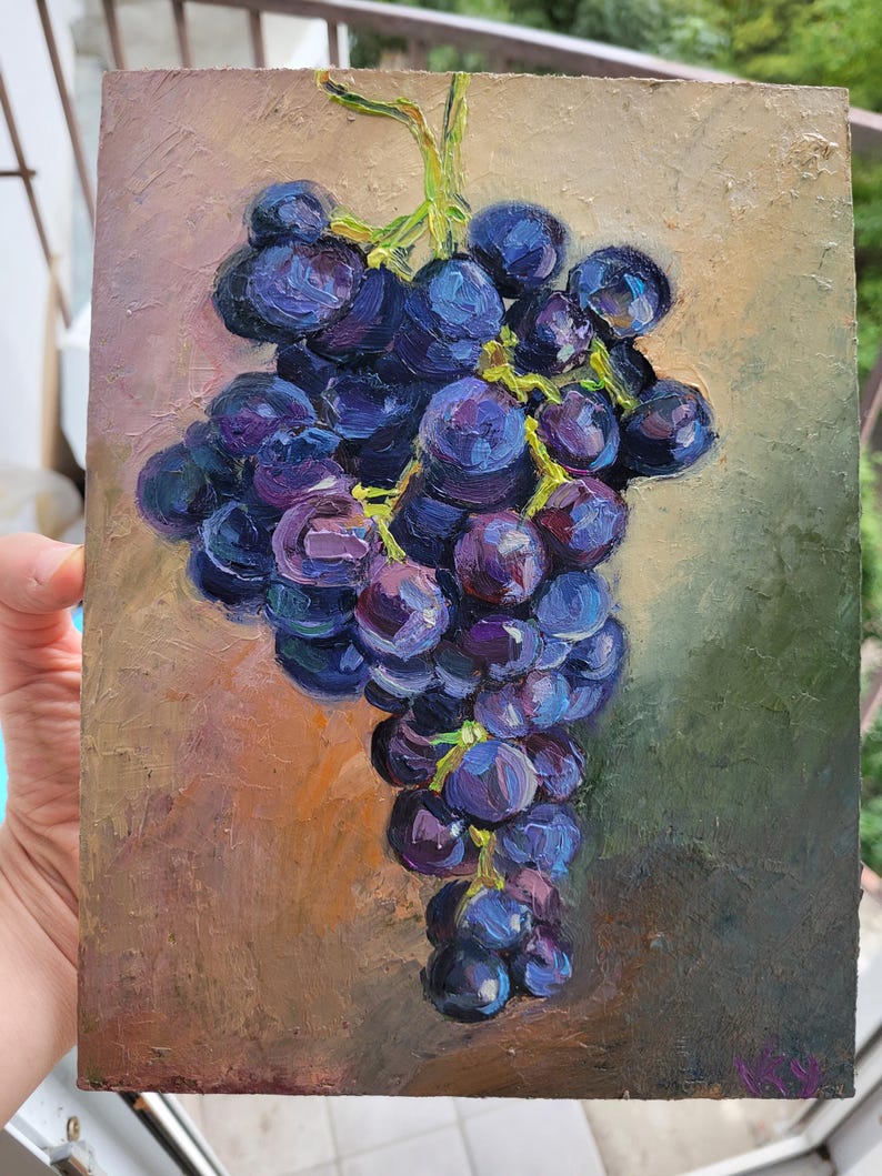 May include: An oil painting on a rectangular canvas depicting a cluster of dark purple and blue grapes with visible green stems. The grapes are rendered with thick, textured brushstrokes against a muted, earthy background of brown and green tones.