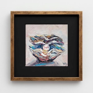 May include: Oil painting of an open oyster shell with a pearl. The artwork features blues, whites, and pinks, with a gold-toned frame and a black mount. The painting is signed in the lower right corner.