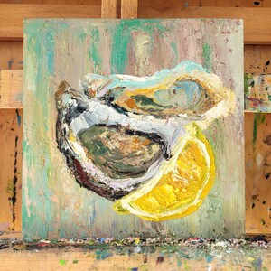 A painting of two oysters and a lemon wedge on a textured green background. The oysters are open and the lemon wedge is cut in half. The painting is done in a loose, impressionistic style.