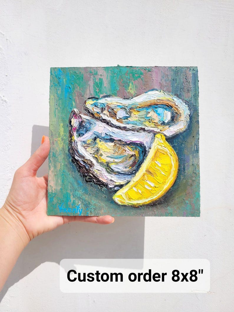 May include: An 8x8 inch oil painting of oysters and a lemon slice. The artwork features textured brushstrokes with a palette of blues, yellows, and whites. The painting is held by a hand against a white background. Text on the painting reads "Custom order 8x8".