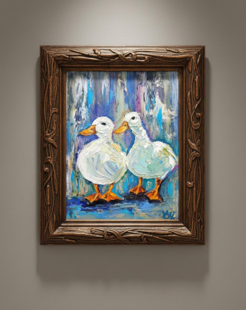 May include: Oil painting of two white ducks with orange beaks and feet, set against a blue and purple background. The artwork is framed in a dark brown, ornate wooden frame, adding a classic touch to the piece.