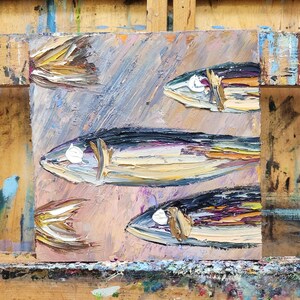 May include: Oil painting of several fish with textured brushstrokes. The fish are painted in shades of blue, yellow, and brown, with white highlights. The background is a blend of pink, blue, and purple hues.