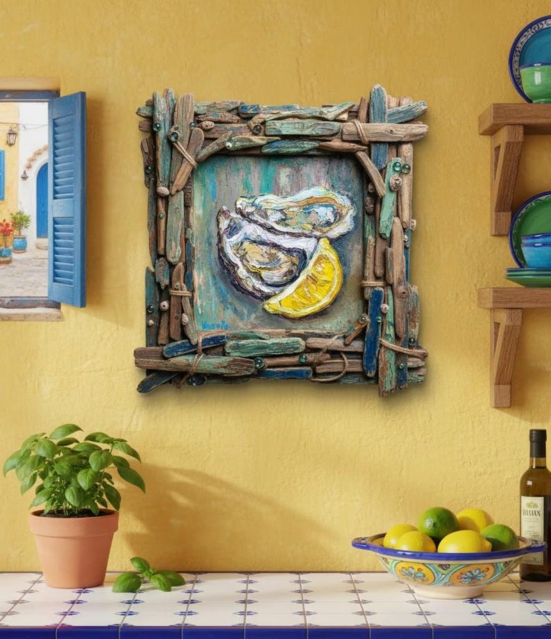 May include: A framed artwork depicts an oyster and lemon slice. The frame is made of driftwood pieces. The artwork is mounted on a yellow wall. A small potted plant and a bowl of lemons are in the foreground.