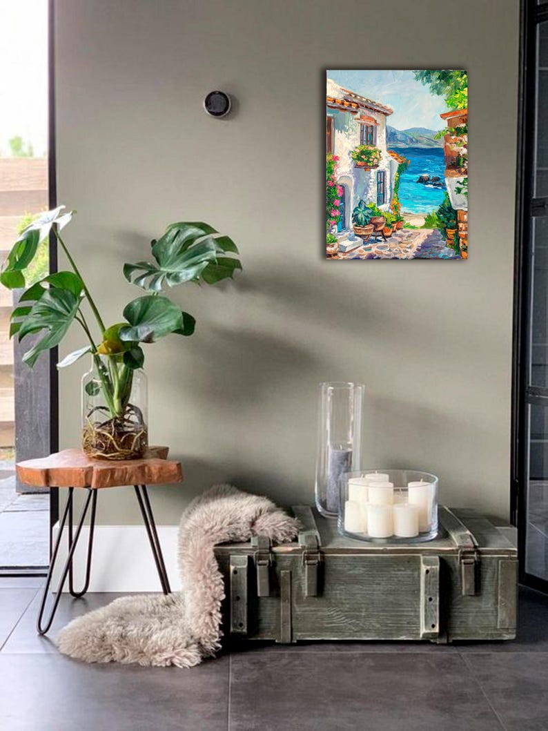 May include: A rectangular oil painting on canvas depicting a Mediterranean coastal scene with a white stone building, vibrant potted flowers, a cobblestone path, and a bright blue sea under a clear sky, displayed in a vertical orientation.