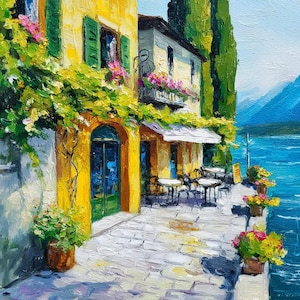 May include: Oil painting of a yellow building with green shutters and a blue door. Pink flowers and green vines adorn the facade. Tables and chairs are set up outside under a white awning, overlooking a blue lake and mountains.