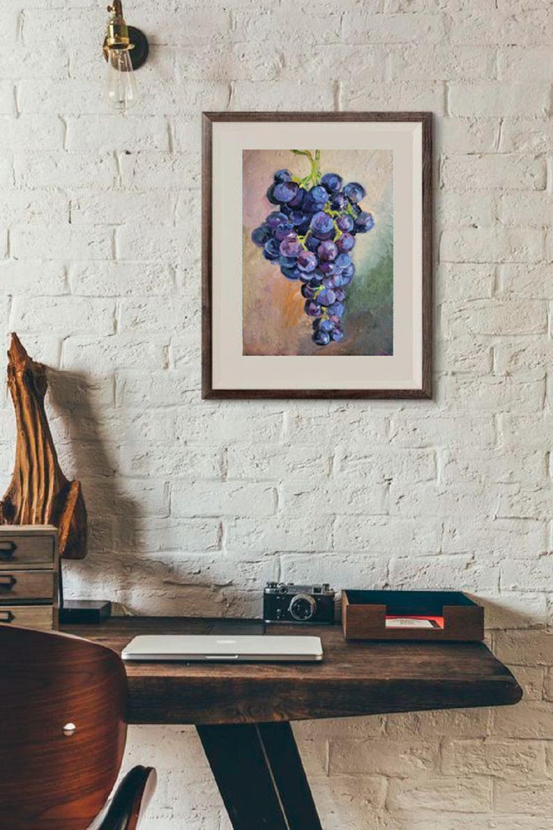 May include: A framed wall art print featuring an oil painting of a cluster of dark purple grapes with green stems. The artwork is rendered in a painterly style with visible brushstrokes, set against a soft, muted background of blended earth tones.