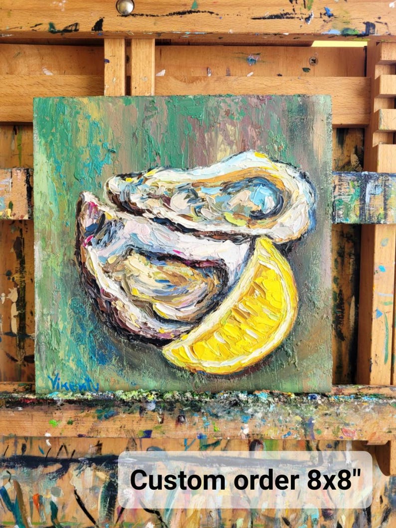 May include: Square 8x8 inch oil painting of oysters and a lemon slice. The artwork features thick brushstrokes in shades of white, yellow, and green. The painting is on a wooden easel. Text on the painting reads "Custom order 8x8".