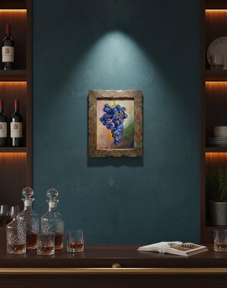 May include: A rectangular framed painting featuring a cluster of dark purple grapes against a soft, blended background of muted green, yellow, and orange tones. The frame has a textured, weathered metallic finish with copper and bronze hues.