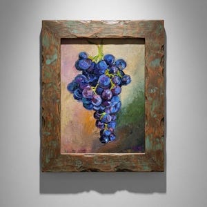 May include: An oil painting of a cluster of dark purple grapes with green stems, rendered with visible brushstrokes. The artwork is encased in a thick, rustic, weathered wooden frame with a textured, distressed brown and green finish.