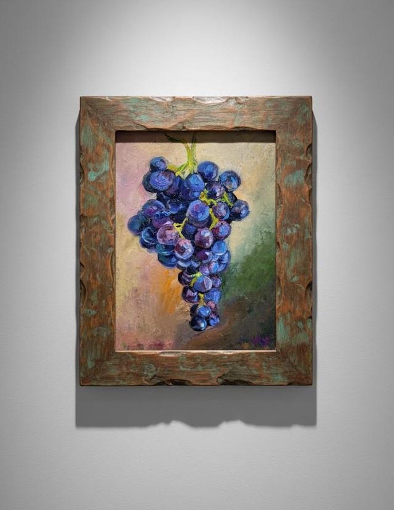 May include: An oil painting of a cluster of dark purple grapes with green stems, rendered with visible brushstrokes. The artwork is encased in a thick, rustic, weathered wooden frame with a textured, distressed brown and green finish.