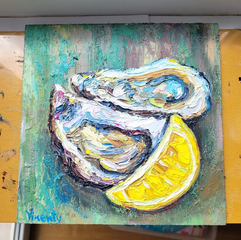 May include: Oil painting of an oyster and a lemon slice. The oyster is painted with thick brushstrokes in shades of white, blue, and brown. The lemon is bright yellow. The background is green with textured brushstrokes. The artist's signature is in the bottom left corner.