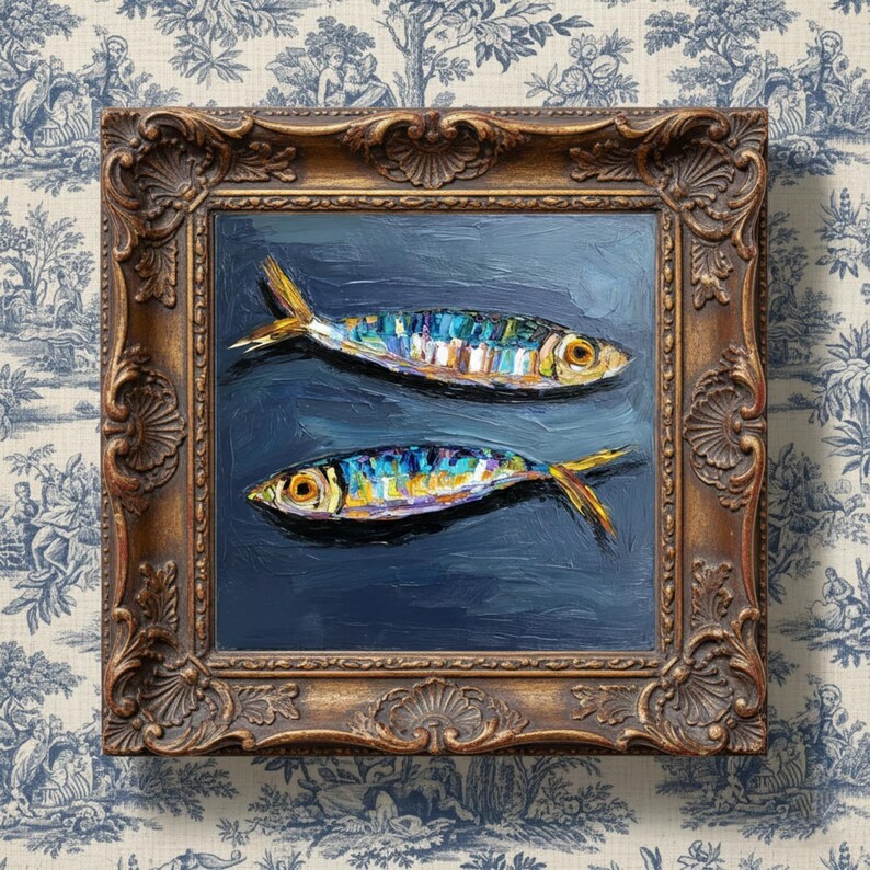 May include: An oil painting featuring two fish with iridescent blue, yellow, and silver scales against a dark navy background. The artwork is encased in an ornate, antique-style gold frame with intricate carved detailing along the edges.