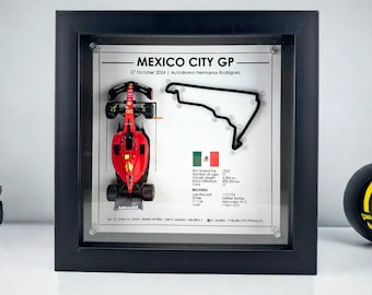 May include: A framed display featuring a miniature red race car and a black track map of the Mexico City Grand Prix. The frame includes the race name, date, and track name, "Mexico City GP, 27 October 2024, Autódromo Hermanos Rodriguez".