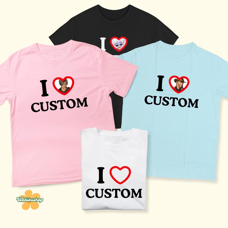 May include: A collection of t-shirts in various colors, including pink, black, and light blue. Each shirt features the text "I &hearts; CUSTOM" with a heart graphic. Some hearts contain images.
