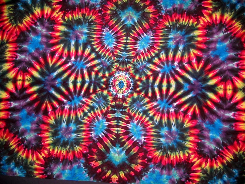 May include: A colorful tie-dye pattern with a central mandala design in shades of red, yellow, blue, and black.