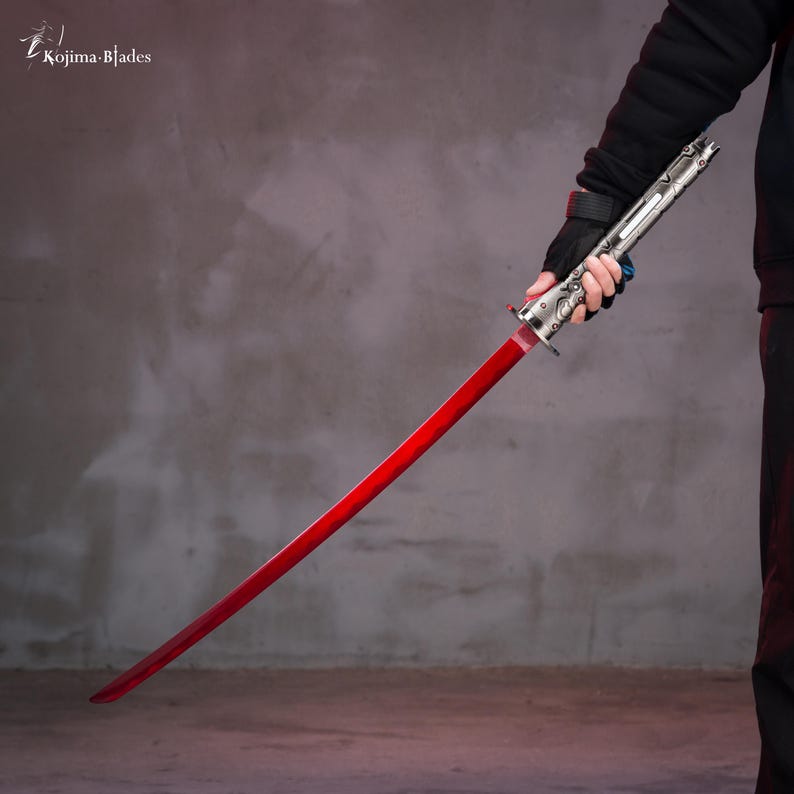 May include: A red katana with a silver blade and a silver handle. The katana is held by a person wearing a black jacket and black gloves.