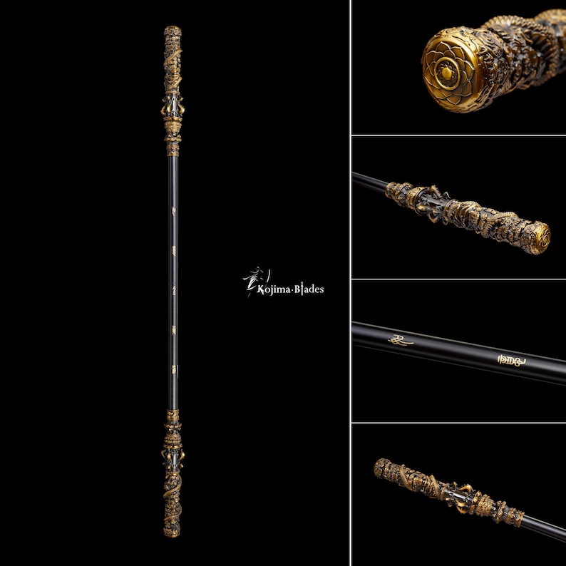 May include: A black staff with ornate gold-colored dragon and floral detailing. The staff has a central shaft with gold accents and the text "Kojima Blades". The ends of the staff are intricately carved with dragons and floral patterns.
