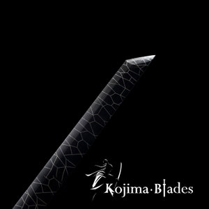 May include: A black sword with a white geometric pattern on the blade. The sword is sharp and pointed. The text "Kojima Blades" is visible in the lower right corner of the image.