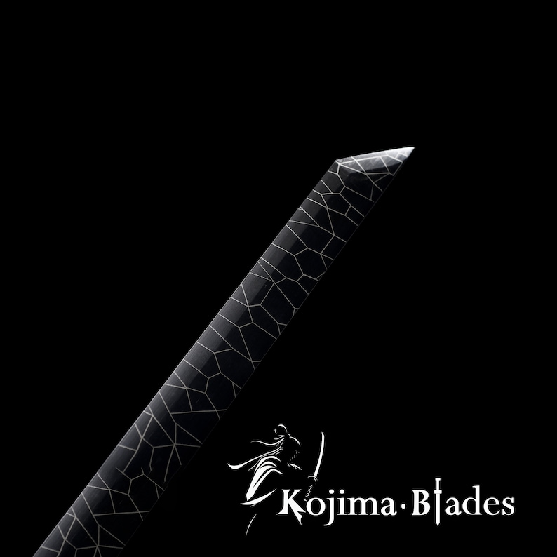 May include: A black sword with a white geometric pattern on the blade. The sword is sharp and pointed. The text "Kojima Blades" is visible in the lower right corner of the image.