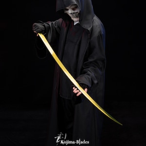 May include: A person wearing a black hooded robe and a skull mask holds a long, thin, gold-coloured sword. The sword is curved and has a sharp point. The person is standing in front of a black background.