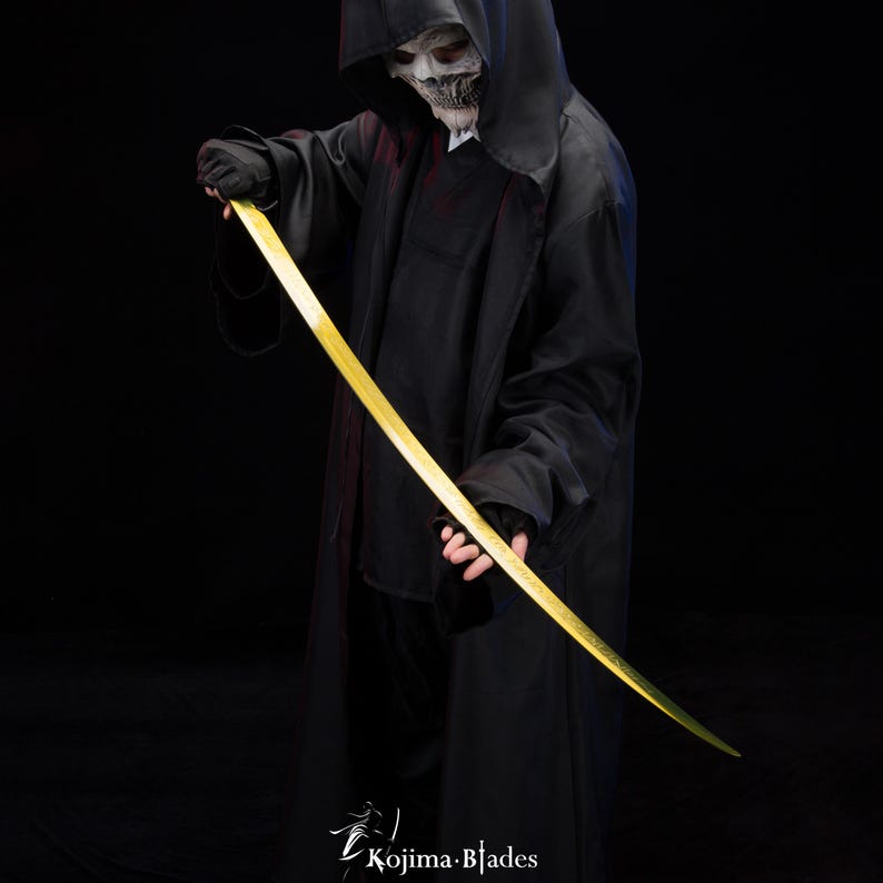 May include: A person wearing a black hooded robe and a skull mask holds a long, thin, gold-coloured sword. The sword is curved and has a sharp point. The person is standing in front of a black background.