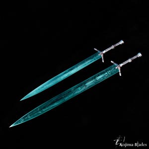 May include: Two swords with blue, translucent blades and silver handles. The blades have intricate designs etched into them.
