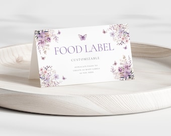 May include: A white printable food label with a purple floral design and butterflies. The text "FOOD LABEL CUSTOMIZABLE" is printed in purple. The text "Duplicate pages to create as many labels as you need." is printed in black.