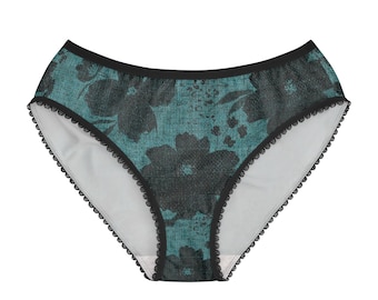 May include: Teal and black underwear featuring a dark floral pattern with a textured appearance. The garment has a solid black waistband and black scalloped lace trim along the leg openings, with a white interior lining visible at the front.