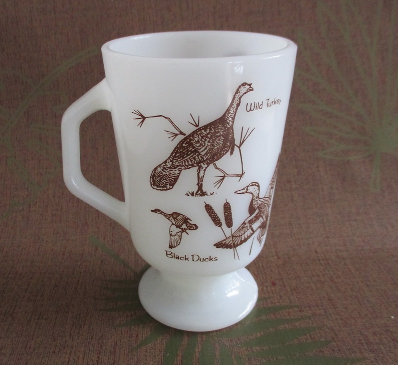 Fire King Wild Birds Milk Glass Footed Mug 5 in. high x 3 in. image 0