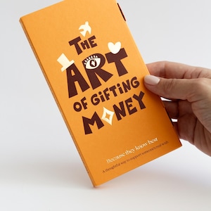 May include: A rectangular orange book titled The Art of Gifting Money in dark brown lettering. The cover features a white bird, a white top hat, a white heart, and a white diamond shape replacing the letter O. Subtext reads Because they know best.