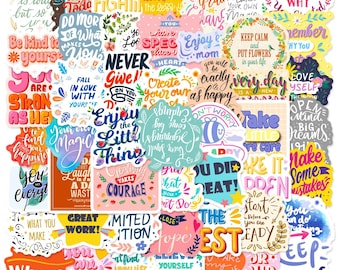 May include: A collection of colorful, inspirational stickers with various quotes and phrases. The stickers feature floral designs, hearts, and stars, with text like "Never Give Up" and "Enjoy the Little Things."