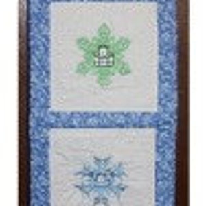 May include: A white quilted wall hanging with blue trim and four embroidered squares. The top square says "Snow Day". The other squares feature different snowflake designs in green, blue, and pink.
