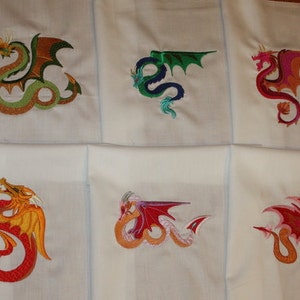 May include: Ten embroidered designs of dragons in various colors, including green, red, pink, and gold. Each dragon is stitched on a white fabric square.